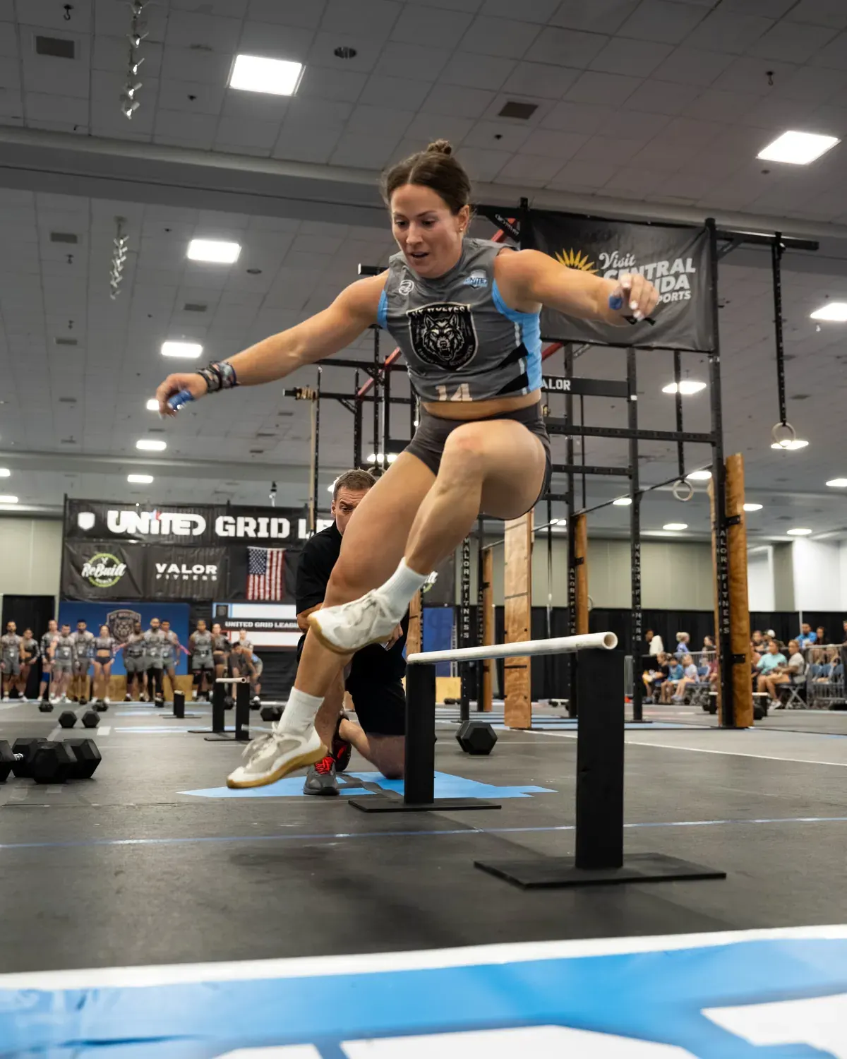 New York Wolves player Kelsey McCall jumping over the pistol stick on one leg in Lakeland