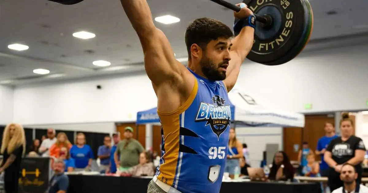 A Tampa Bay Brigade player drives a barbell overhead on a snatch against the New York Wolves in Lakeland, Florida.