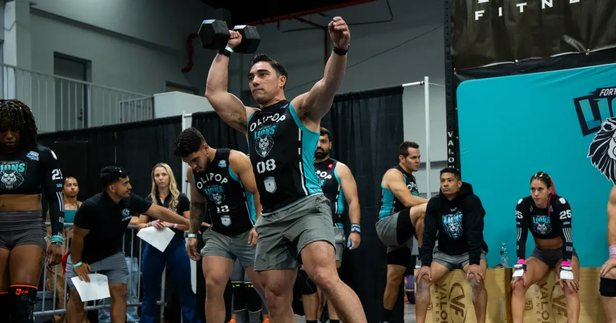 A Fort Lauderdale Lions athlete drives a dumbbell overhead during the 2026 United Grid League opening day in Miami.