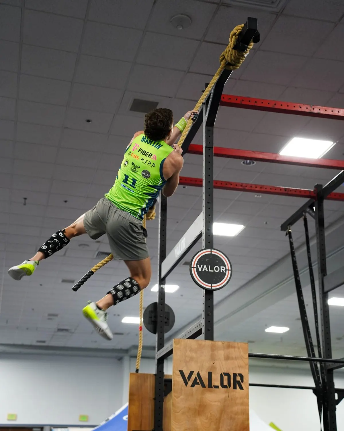 A Grid League athlete climbs the rope on the rig during a race at the Lakeland match day on June 20, 2026.