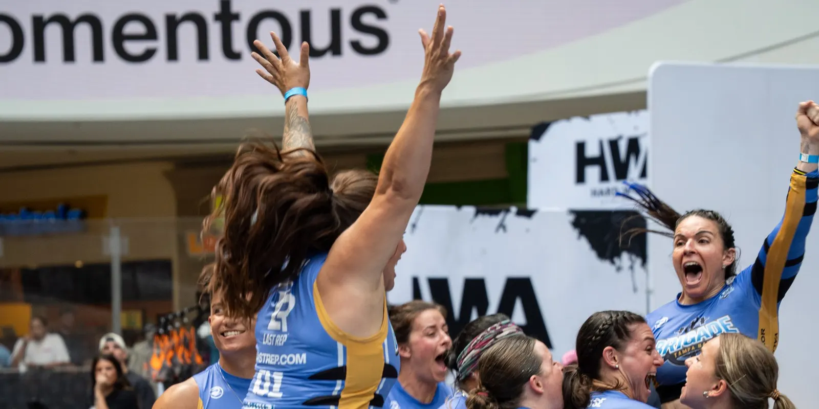 Tampa Bay Brigade athletes celebrate with arms raised at United Grid League Week 3 at American Dream.