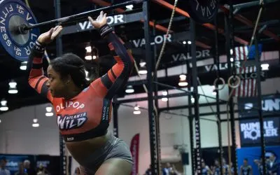 Grid League athlete pressing a barbell overhead