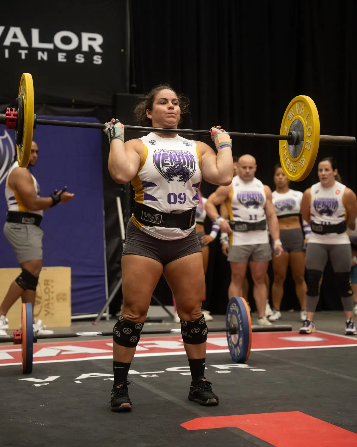 Las Vegas Venom player cleans the barbell in the Partner Forward