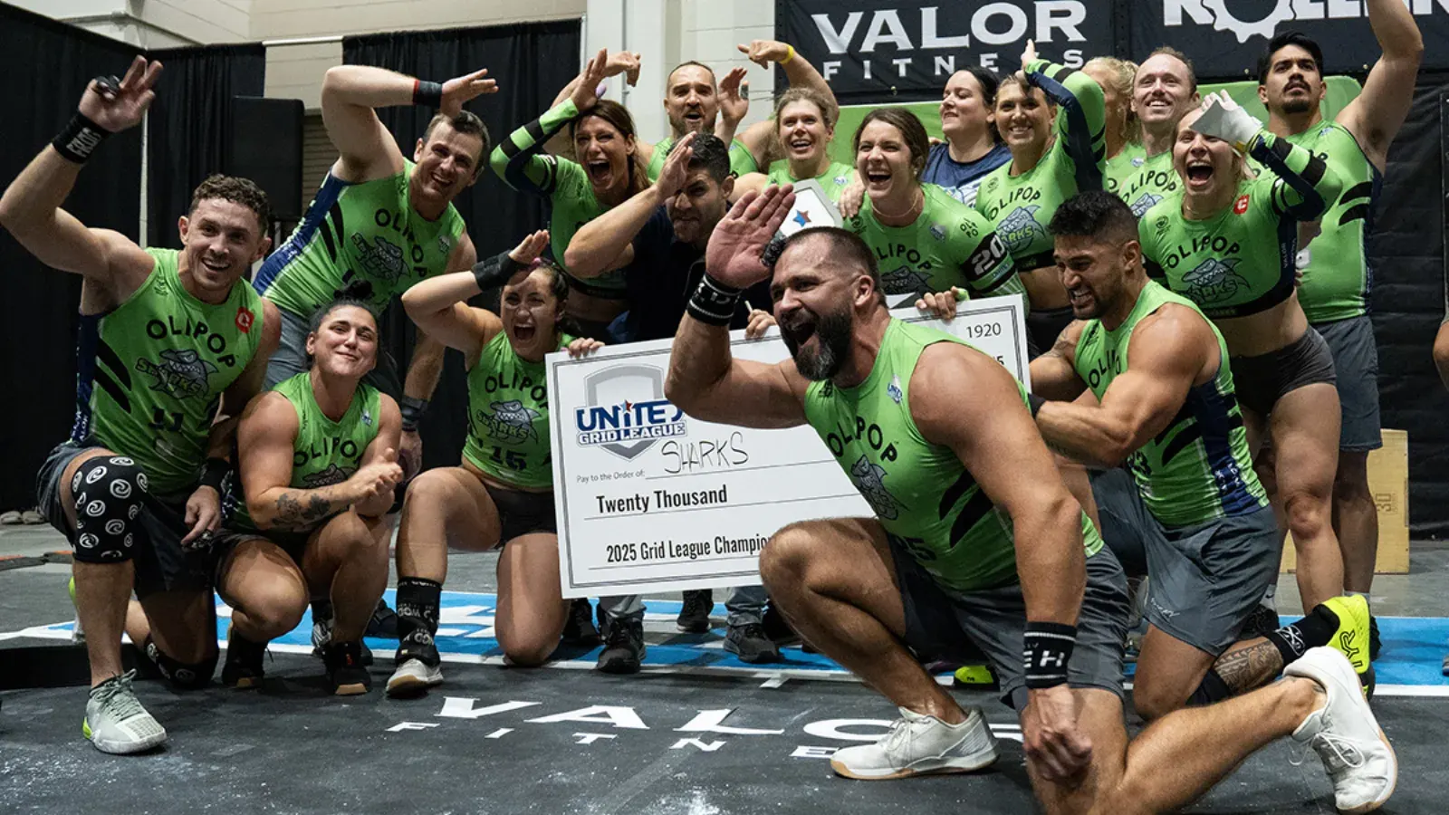 A Grid League team celebrating on the championship floor with the winners cheque