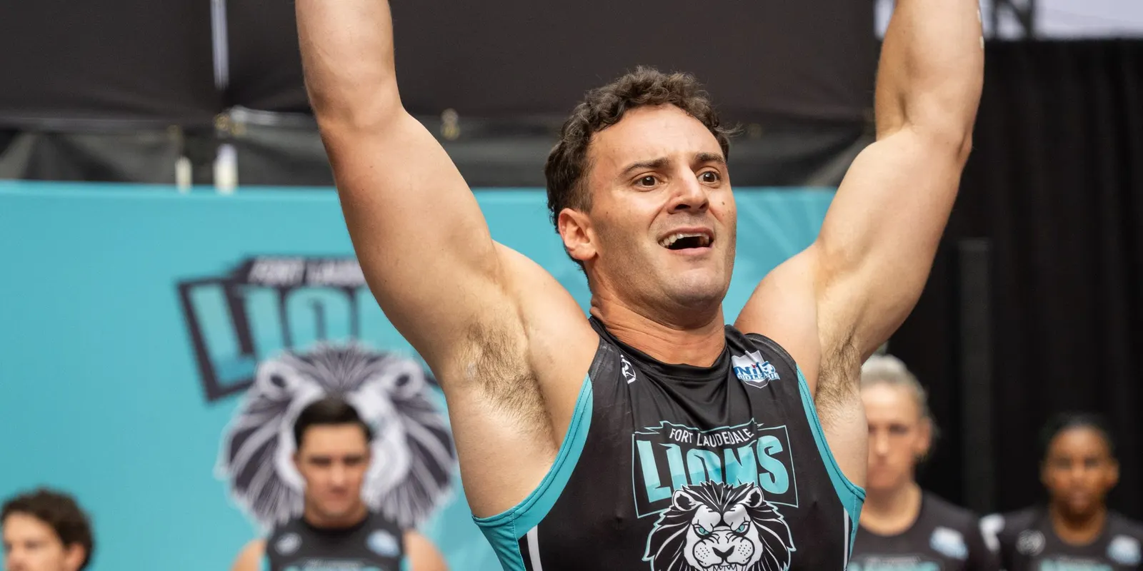 A Fort Lauderdale Lions athlete raises both arms in celebration at United Grid League Week 3 at American Dream.