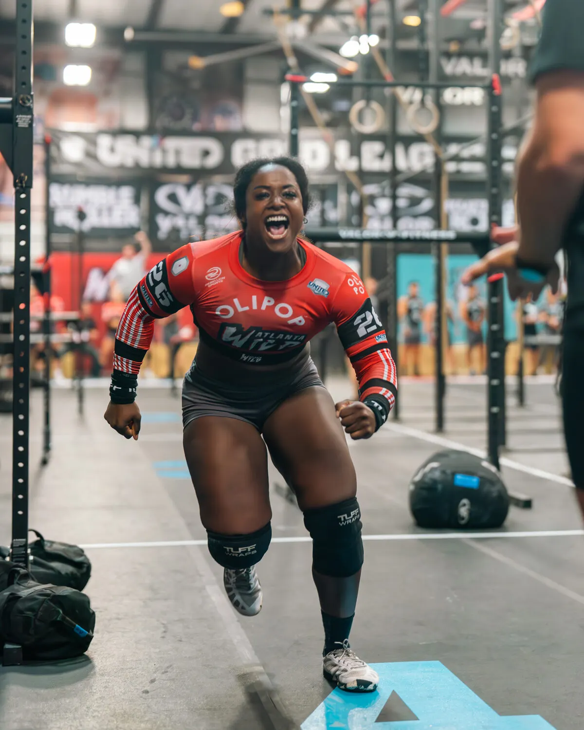 Sidney Wilson celebrates on the Grid floor in her red Atlanta Wild jersey.
