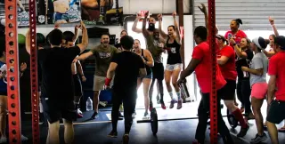 Players cheering together at the finish of an all levels Grid League Community Day race