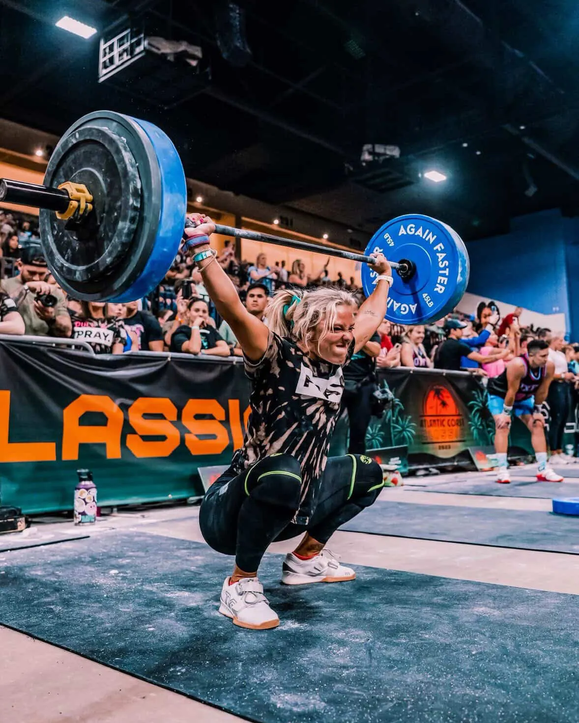 Carolina Flight rookie HaleiJo Fuller-Arroyo catches a barbell overhead in a squat at a fitness competition.