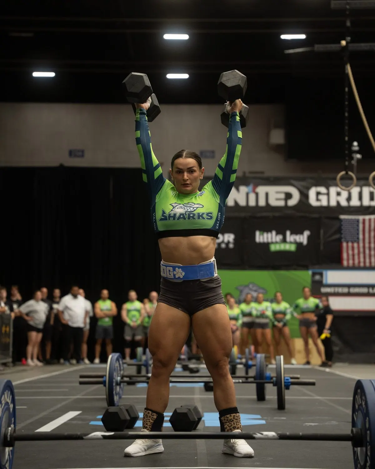 Southwest Florida Sharks player Kyra Milligan presses two dumbbells overhead