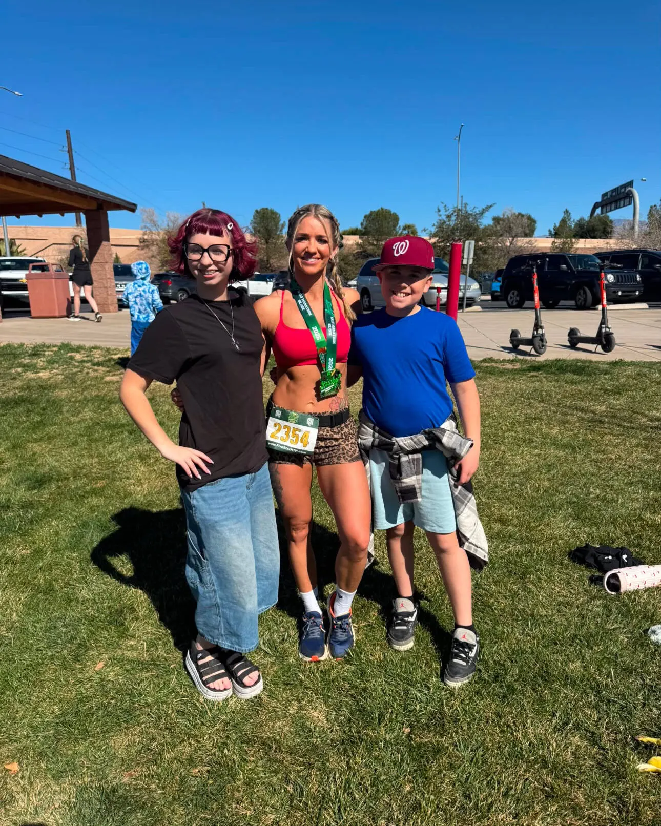 Carolina Flight rookie Mikail Jenkins stands with her two kids after finishing her half marathon.