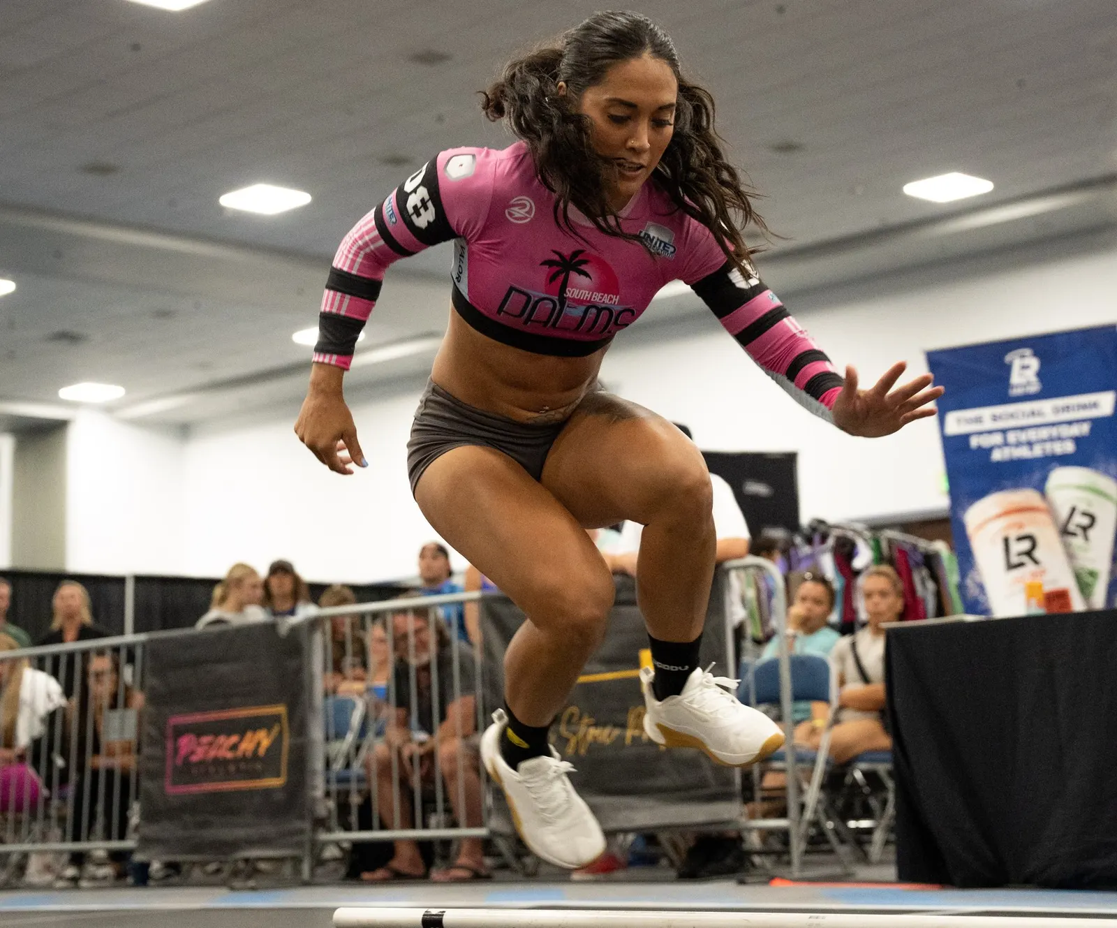Heather Hudson of the South Beach Palms jumps over the barbell during a Grid League match in Lakeland.