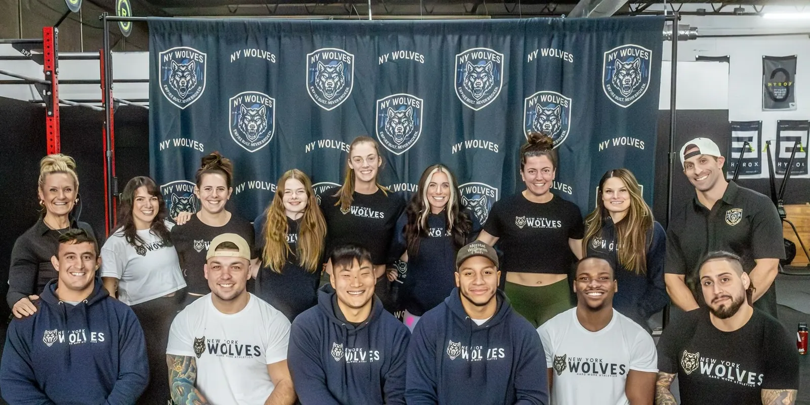 The New York Wolves roster poses in front of the team banner.