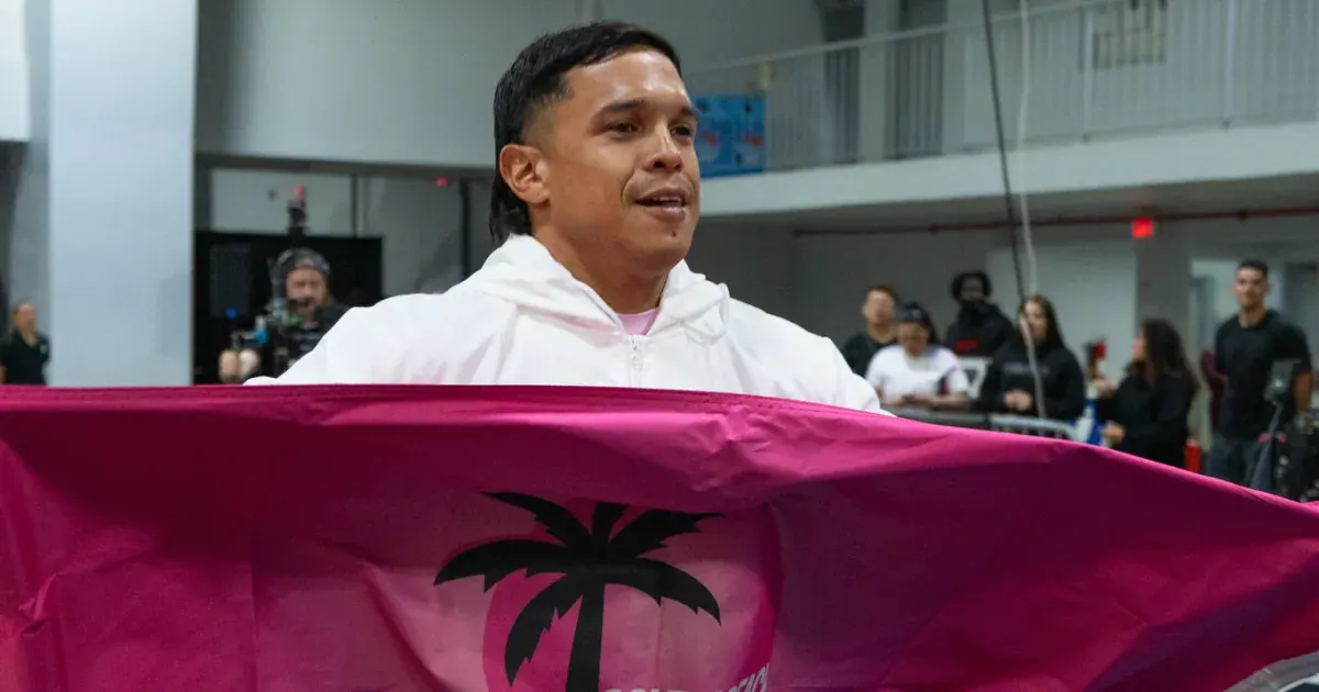 A South Beach Palms athlete carries the team flag during the 2026 United Grid League opening day in Miami.