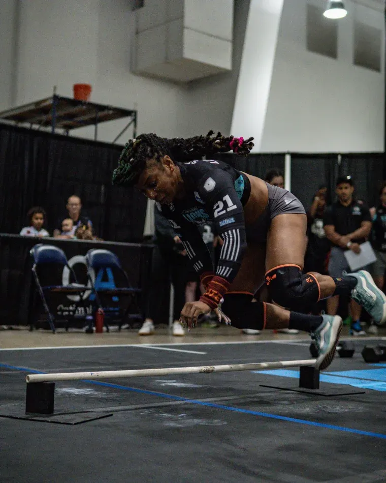 Janine Nicole of the Fort Lauderdale Lions clearing the bar on a bar facing burpee at the Grid League season finale in Dallas