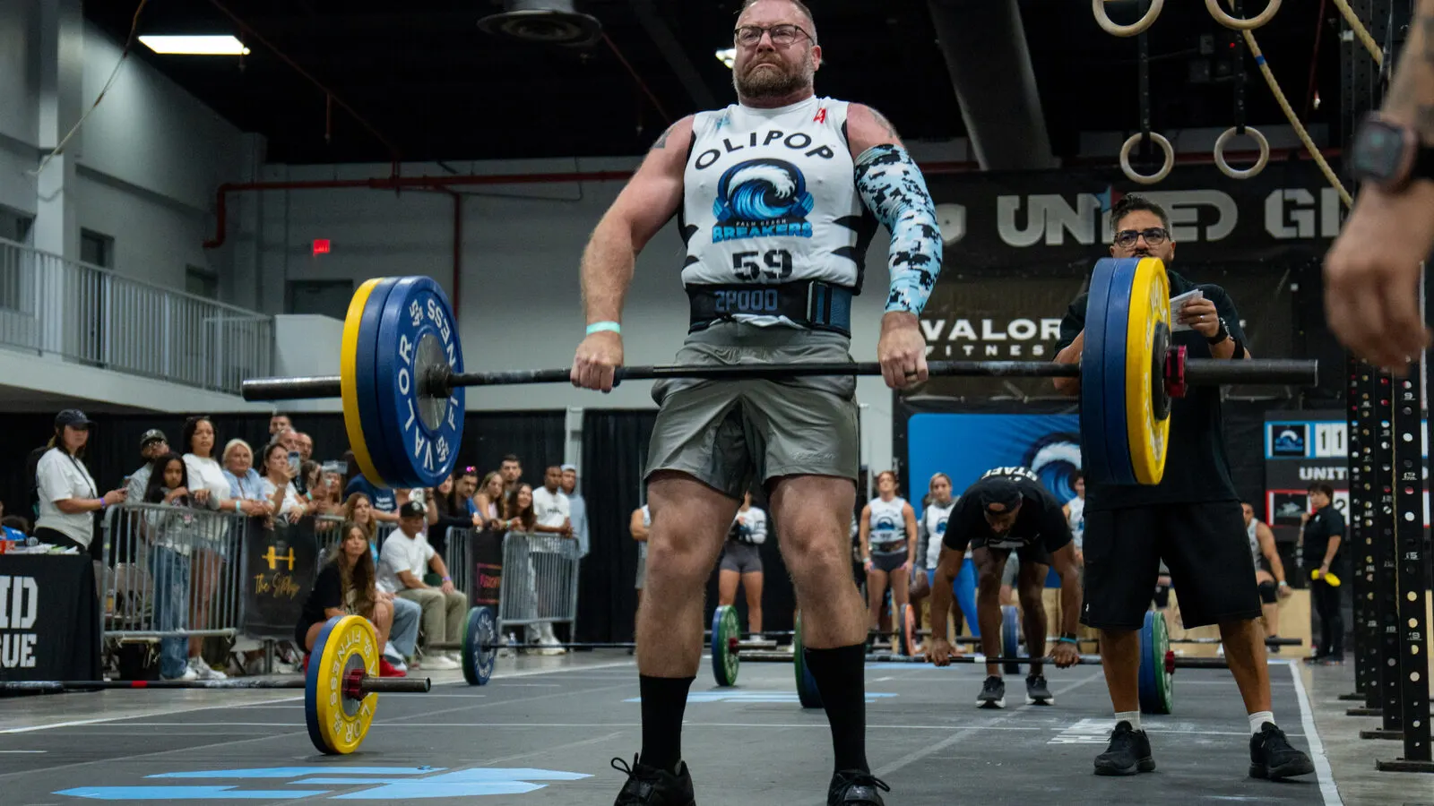 Grid League players race head to head at a barbell station